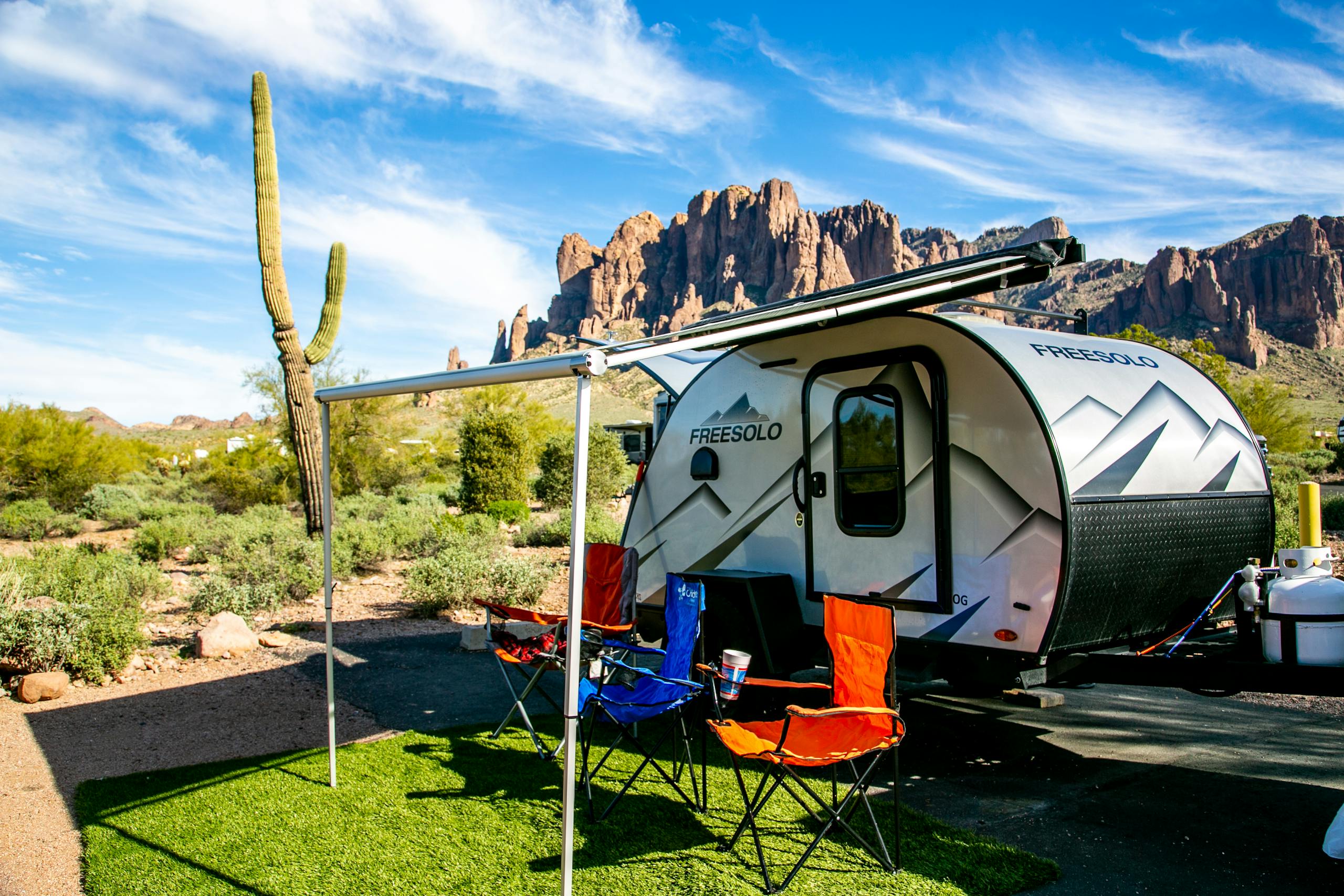 Explore breathtaking camping views at Apache Junction with a camper and iconic cactus backdrop.