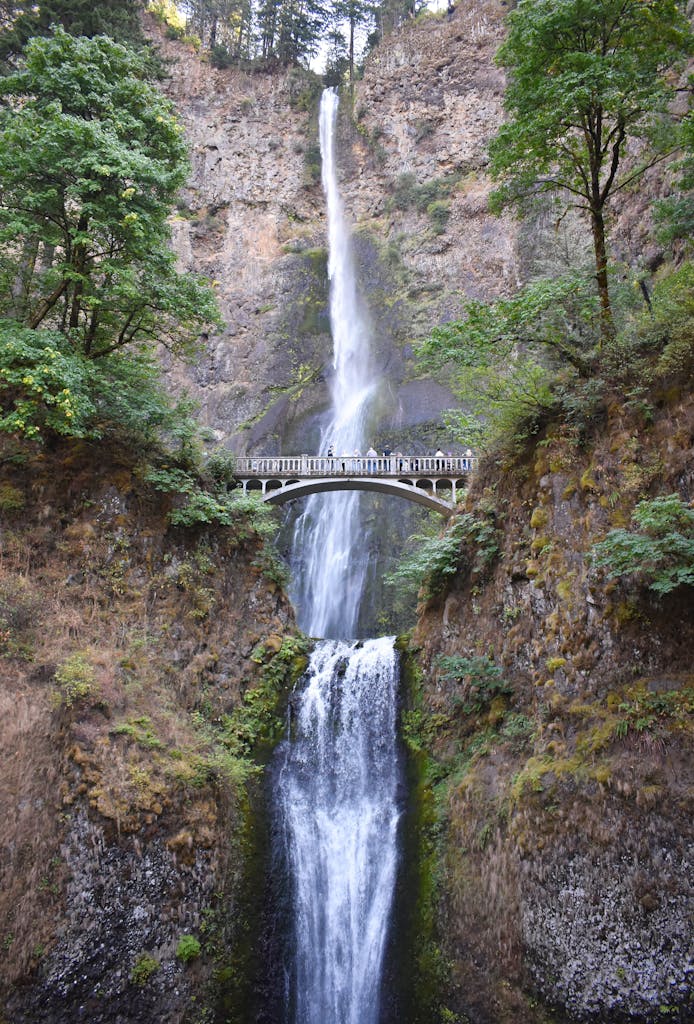 Stunning Multnomah Falls in Oregon cascades over rocks under a beautiful footbridge.